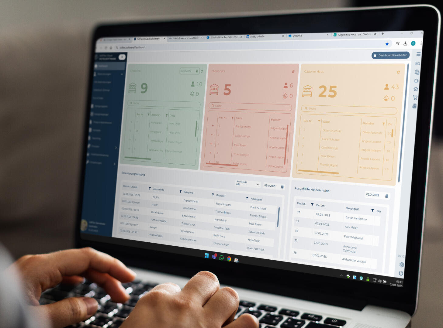 Une personne tape sur un ordinateur portable affichant un tableau de bord avec des sections vertes, rouges et oranges montrant diverses données numériques et de liste, ainsi que des menus de navigation à gauche et des tableaux en bas.